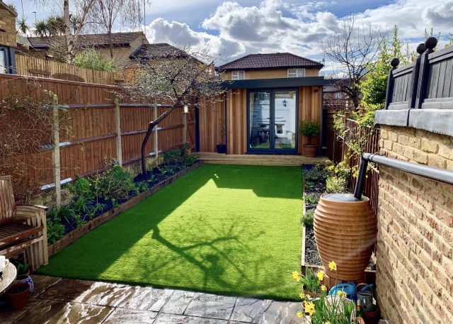 artificial grass for gardens with patio and plants